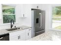 Well-lit kitchen boasts granite countertops, stainless steel appliances, and ample cabinet space at 1570 Childress Sw Dr, Atlanta, GA 30311