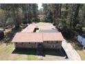 A captivating aerial view of a brick home with an extensive roof, showcasing its unique layout and spacious surroundings at 5159 Covington Hwy, Decatur, GA 30035