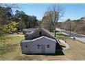 The rear of the home features a siding exterior and a modest yard, situated by a highway at 5181 Covington Hwy, Decatur, GA 30035