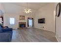 Bright living room with a stone fireplace, high ceilings, ceiling fan, and neutral walls at 10 Flowers Dr, Covington, GA 30014