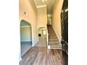 Inviting foyer with hardwood floors, leading to a carpeted staircase and living spaces at 4244 Old House Dr, Conley, GA 30288