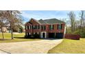 Well-maintained brick home with a spacious driveway and lush green lawn at 4244 Old House Dr, Conley, GA 30288