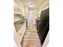 Functional kitchen with sleek, stainless steel appliances and bright white cabinets at 5050 Martins Crossing Rd, Stone Mountain, GA 30088