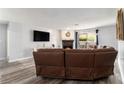 Cozy living room with a fireplace, large sectional sofa, and sliding glass doors to a patio at 813 Ridgefield Dr, Peachtree City, GA 30269