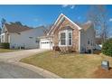 Attractive home with stone accents, a two-car garage, and a landscaped yard at 2130 Birkdale St, Villa Rica, GA 30180