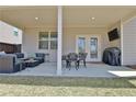 Covered patio with outdoor furniture, a mounted TV, and a grill for entertaining and relaxation at 516 Cunninghame Ct, Peachtree City, GA 30269