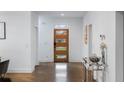 Bright entryway features a modern wood door, hardwood floors, and neutral decor at 1560 New Ne St, Atlanta, GA 30307