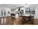 Open-concept kitchen and dining area featuring stainless steel appliances and modern lighting at 1560 New Ne St, Atlanta, GA 30307