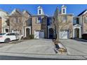 Charming brick townhome with manicured landscaping and attached one car garage at 1749 Coleville Oak Ln, Lawrenceville, GA 30046