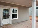 The covered back porch features durable siding and a convenient door for easy outdoor access at 2096 Boxwood Cir, Conyers, GA 30094