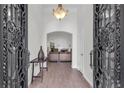 Inviting foyer showcases an arched doorway, wood floors, decorative light fixture, and elegant wrought iron door at 2250 Snug Ne Hbr, Marietta, GA 30066