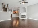 Living room with dark wood floors, fireplace, staircase, and view of the kitchen at 2360 Johnson Rd, Atlanta, GA 30345
