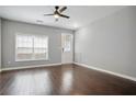 Bright living room with dark wood floors, neutral walls, and ceiling fan at 2360 Johnson Rd, Atlanta, GA 30345
