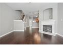 Living room with dark wood floors, fireplace, and staircase leading to upper level at 2360 Johnson Rd, Atlanta, GA 30345