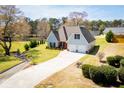 Inviting two-story home featuring an attached garage and beautifully landscaped grounds at 207 Meadow Lake Dr, Carrollton, GA 30116
