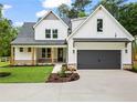 Beautiful new construction home featuring board and batten siding and a spacious driveway at 1698 Cunningham Sw Rd, Marietta, GA 30008