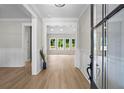 Bright foyer with wood floors and a view into the open-concept living area at 1698 Cunningham Sw Rd, Marietta, GA 30008