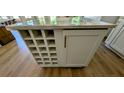 Kitchen island with wine rack and cabinets on hardwood floor at 1698 Cunningham Sw Rd, Marietta, GA 30008