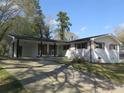 Charming single-story home with a white brick facade, brown shutters, and a spacious front yard at 3531 Creighton Sw Rd, Atlanta, GA 30331