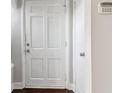 Interior view of a white paneled entry door and trim complemented by the neutral walls at 1563 Mayflower Sw Ave, Atlanta, GA 30311