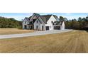 Attractive two-story white brick home with long driveway and well-manicured lawn at 2485 Brooks Rd, Dacula, GA 30019