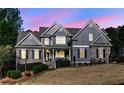 Charming two-story home with stone accents, beautiful landscaping, and a welcoming front porch at 304 Gilmer Ct, Canton, GA 30115