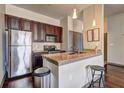 This kitchen features stainless steel appliances and a granite countertop with barstool seating at 898 Oak Sw St # 1101, Atlanta, GA 30310