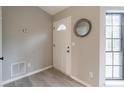 Inviting foyer with natural light and sleek wood-look floors at 3814 Whaley Ct, Snellville, GA 30039
