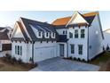Stunning two-story home with a white exterior, dormer windows, and an attached two-car garage at 486 Broom Dr, Cumming, GA 30040