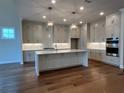 Gourmet kitchen with ample cabinetry, expansive island, and stainless steel appliances at 486 Broom Dr, Cumming, GA 30040