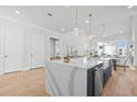 Bright and airy kitchen showcasing a large island, stainless steel sink, and adjacent dining area at 486 Broom Dr, Cumming, GA 30040