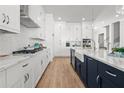 Elegant kitchen with white cabinets, stainless steel appliances, and a contrasting navy blue island at 486 Broom Dr, Cumming, GA 30040