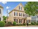 Attractive home exterior with stone accents, yellow siding, brown shutters, and lush landscaping at 4224 Gateland Ave, Marietta, GA 30062