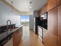 Kitchen featuring stainless steel appliances, dark granite countertops, and hardwood floors at 923 Peachtree Ne St # 1334, Atlanta, GA 30309
