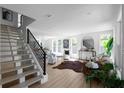 Bright living room featuring a staircase, large windows, and stylish decor at 3336 Myrtle St, Atlanta, GA 30354