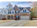 Beautiful two-story brick home featuring a covered porch, attached two car garage and meticulously maintained landscaping at 4803 Austin Hills Dr, Suwanee, GA 30024