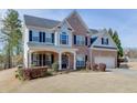 Attractive two-story home with brick and siding, offering a welcoming front porch and a spacious two-car garage at 4803 Austin Hills Dr, Suwanee, GA 30024