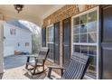 Inviting front porch with seating, showcasing the home's architectural details and a cozy outdoor space at 4803 Austin Hills Dr, Suwanee, GA 30024