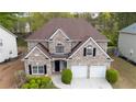 A stately two-story brick home featuring a two-car garage and professional landscaping at 1074 Frog Leap Nw Trl, Kennesaw, GA 30152