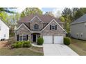 Beautiful two-story brick home with a two-car garage and manicured landscaping at 1074 Frog Leap Nw Trl, Kennesaw, GA 30152