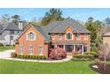 Manicured lawn leads up to this charming two-story brick home with a covered front entrance at 5124 Parkwood Oaks Ln, Smyrna, GA 30126