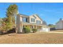 Inviting two-story home with a charming front porch, attached garage, and landscaped yard at 4785 Beaver Rd, Loganville, GA 30052