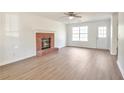 Bright living room showcasing a brick fireplace, new floors, and ample natural light at 4785 Beaver Rd, Loganville, GA 30052