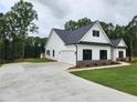 New construction home featuring white siding, a spacious driveway, and an attached two-car garage at 490 Benson Meadows Dr, Dallas, GA 30157