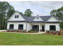 Beautiful new single-story home with white siding, stone accents, and a well-manicured lawn at 490 Benson Meadows Dr, Dallas, GA 30157