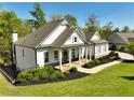 Attractive single-story home with a covered front porch, well-manicured lawn, and established landscaping at 305 Red Gate Ln, Canton, GA 30115