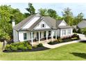 Beautiful craftsman-style home featuring a landscaped yard, and a welcoming front porch at 305 Red Gate Ln, Canton, GA 30115