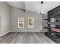 Bright living room featuring high ceilings, a fireplace, and large windows offering plenty of natural light at 3690 Darrah Sw Way, Atlanta, GA 30331
