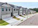 Beautiful new townhomes line the street with individual garages and meticulously maintained landscaping at 1357 Fern Ridge Ct # 30, Norcross, GA 30093