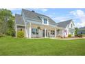 Inviting front porch with rocking chairs and an American flag on a well-manicured lawn at 20 Tuscany Dr, Mansfield, GA 30055